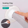 A hand applies sealing clay to a pipe and wall hole using a tool for waterproofing and oil-proofing.