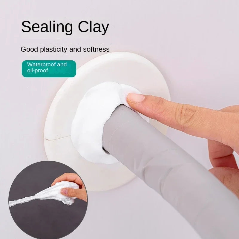 A hand applies sealing clay to a pipe and wall hole using a tool for waterproofing and oil-proofing.