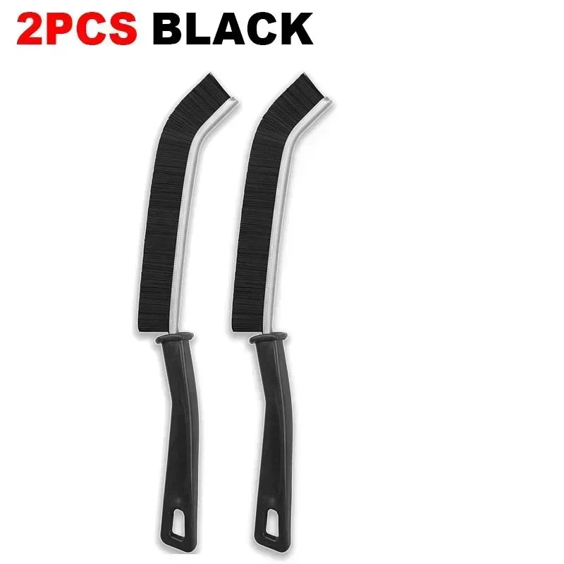 Two black durable hard-bristle crevice cleaning brushes.