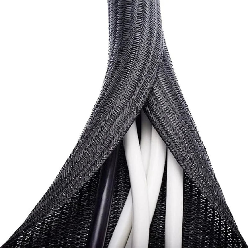 Close-up view of black braided cable sleeves with white inner wires.