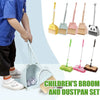 A children's broom and dustpan set with a yellow handle and green bristles shown next to a child's hand.
