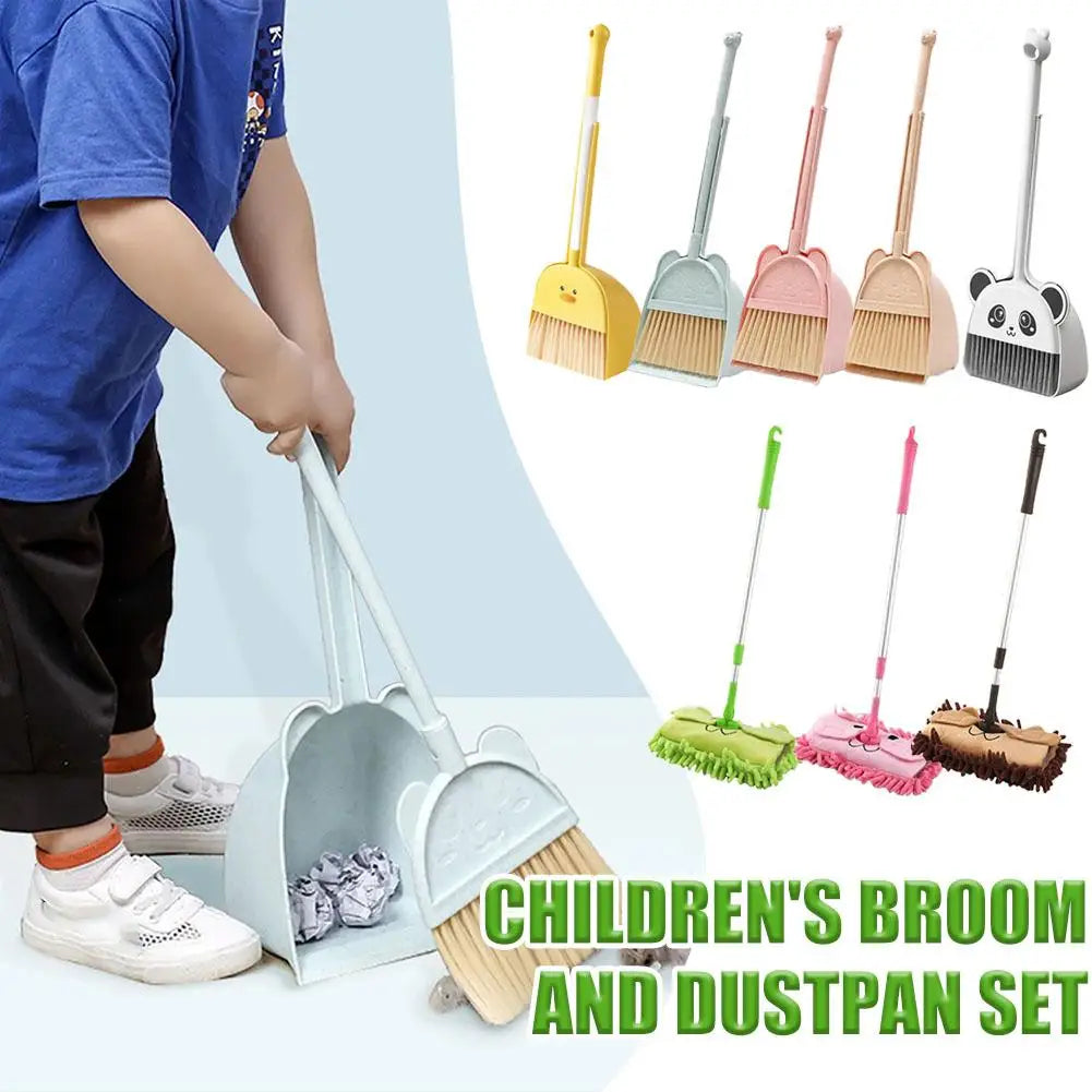 A children's broom and dustpan set with a yellow handle and green bristles shown next to a child's hand.