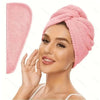 A woman wearing a pink microfiber hair towel wrap on her head.