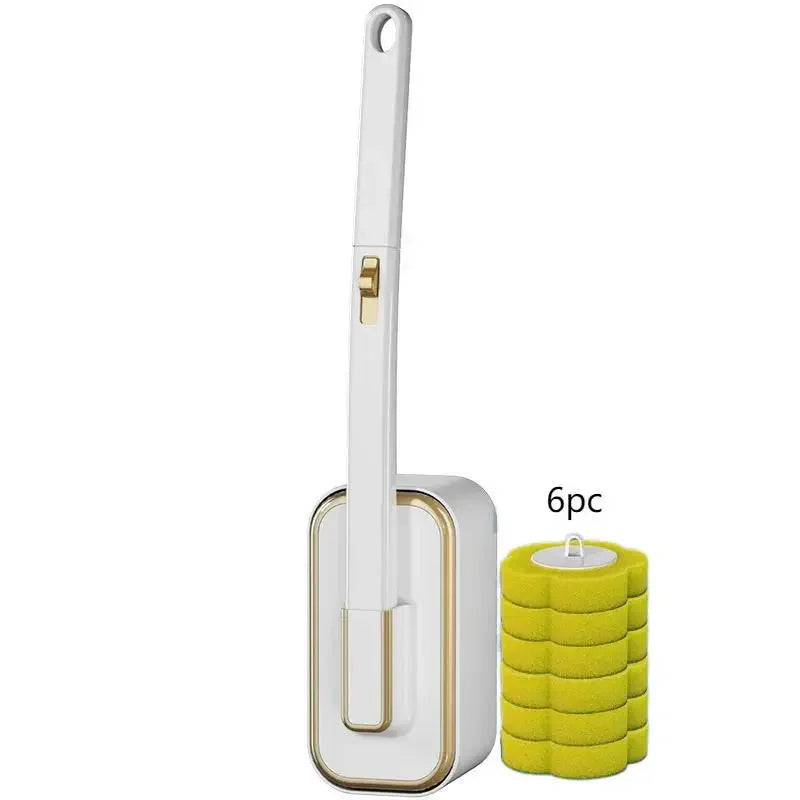 A white disposable toilet cleaning brush next to a stack of yellow cleaning pads.