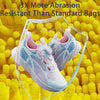 A pair of light blue and pink athletic shoes inside a clear plastic bag against a yellow textured background.
