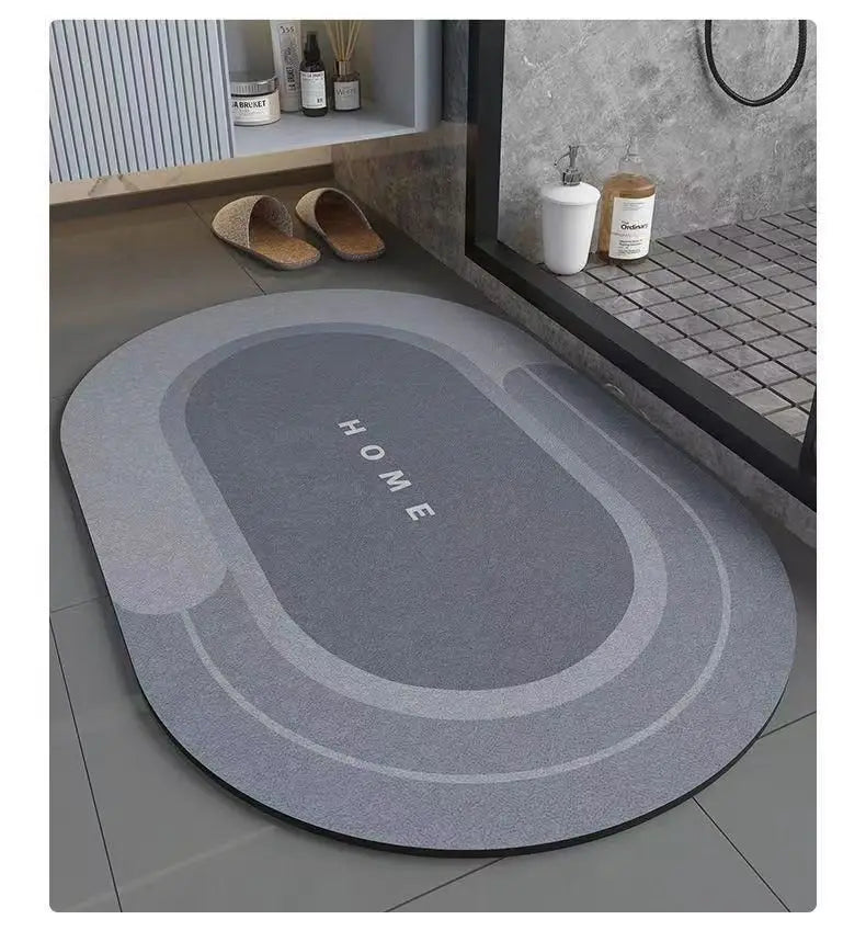 A gray anti-slip floor mat with the word HOME embossed on it placed on a light-colored floor.