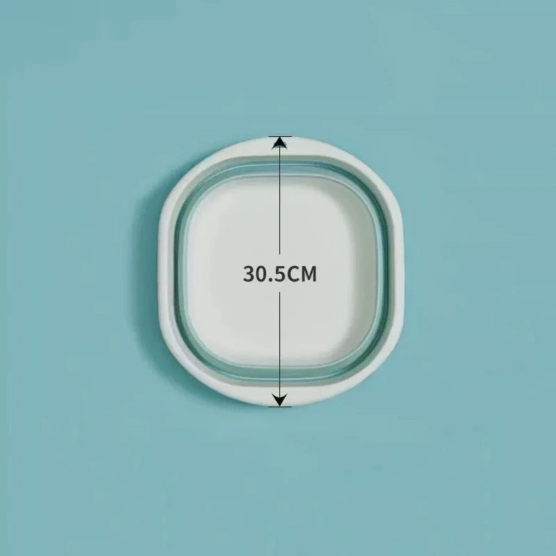 A white foldable plastic wash basin shown from above with dimension markings.