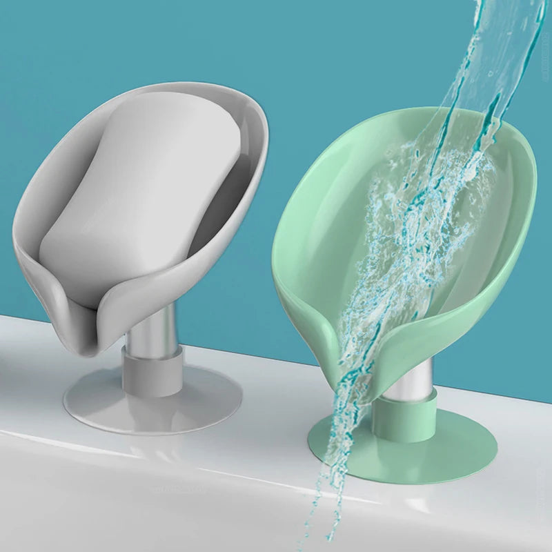 A leaf-shaped suction cup soap dish in mint green is shown with water flowing from it.