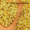 A pile of small, round, solid gold metal ingots on a hand.