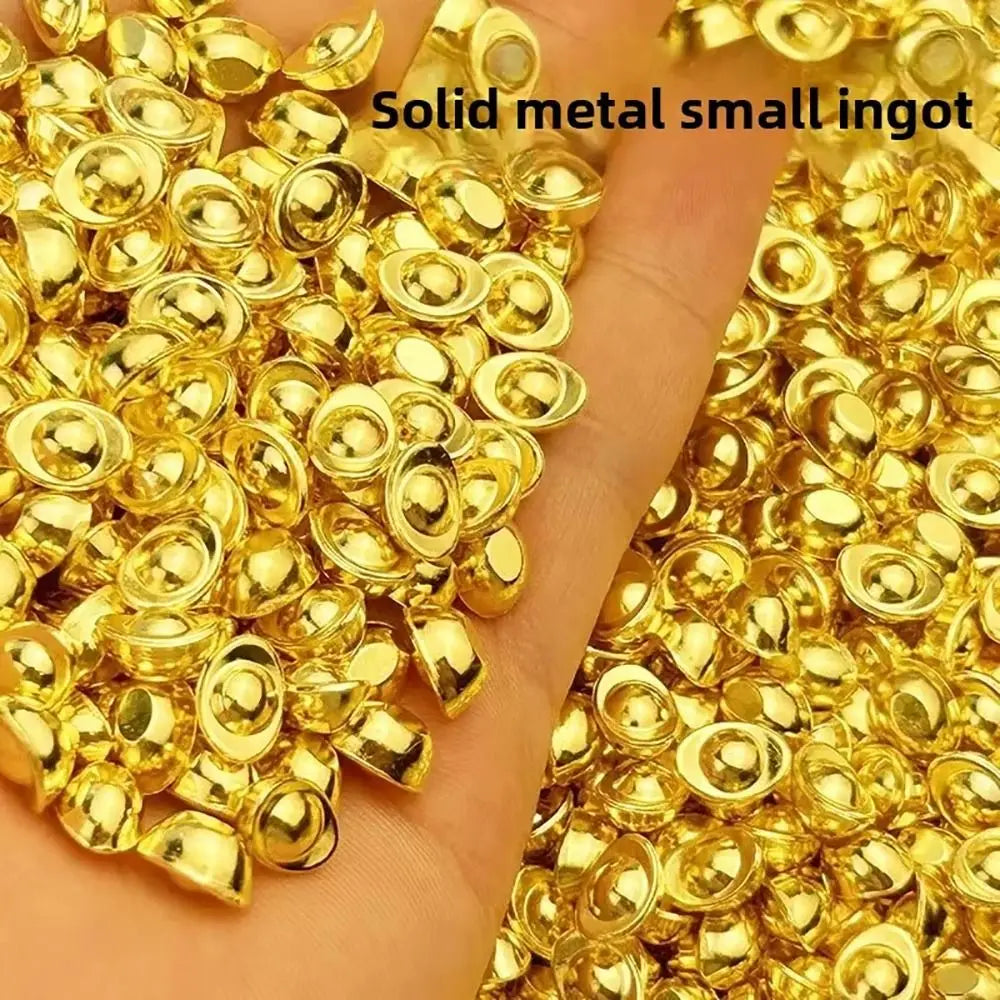 A pile of small, round, solid gold metal ingots on a hand.