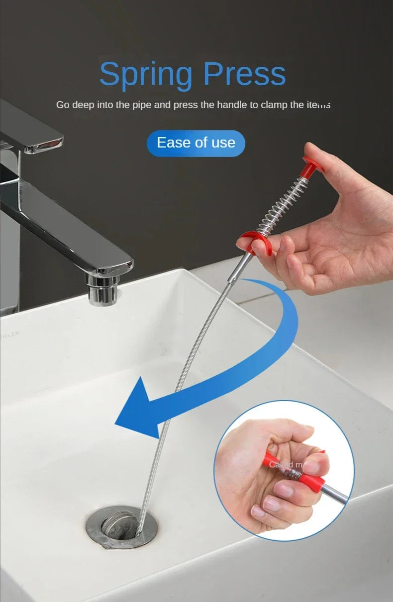 A hand is using a Spring Press tool to unclog a sink drain pipe.