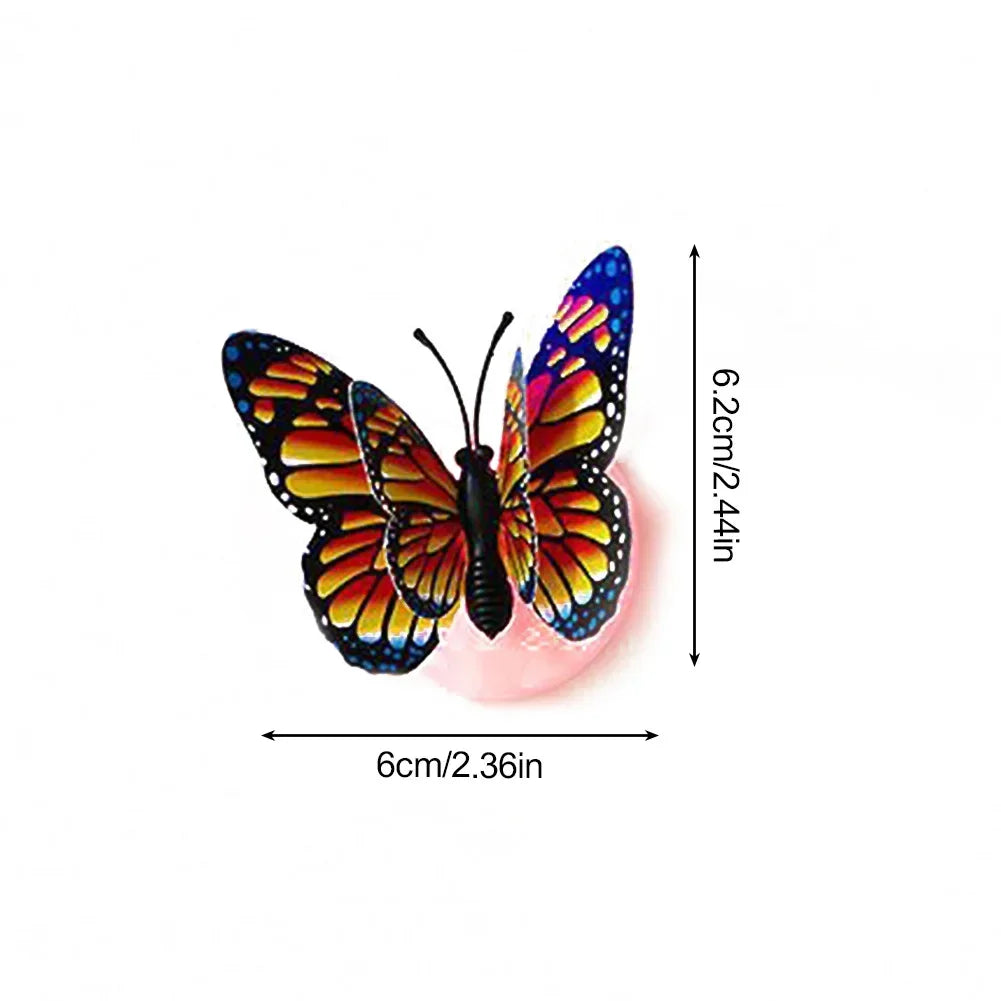 A luminous 3D butterfly wall light with vibrant orange and black wings, measuring 6cm long and 6.2cm high.