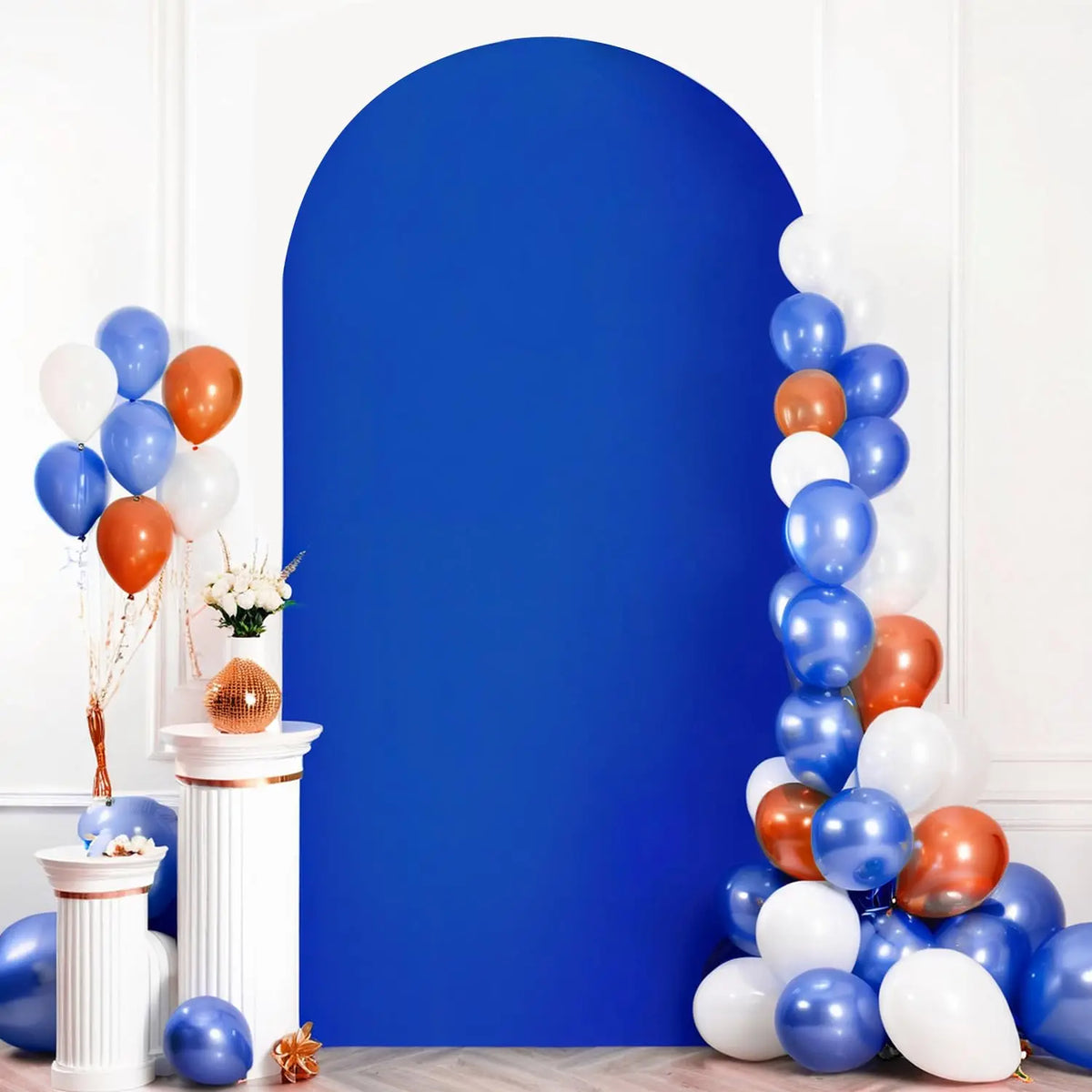 A vertical arrangement of blue and orange balloons against a large royal blue backdrop.