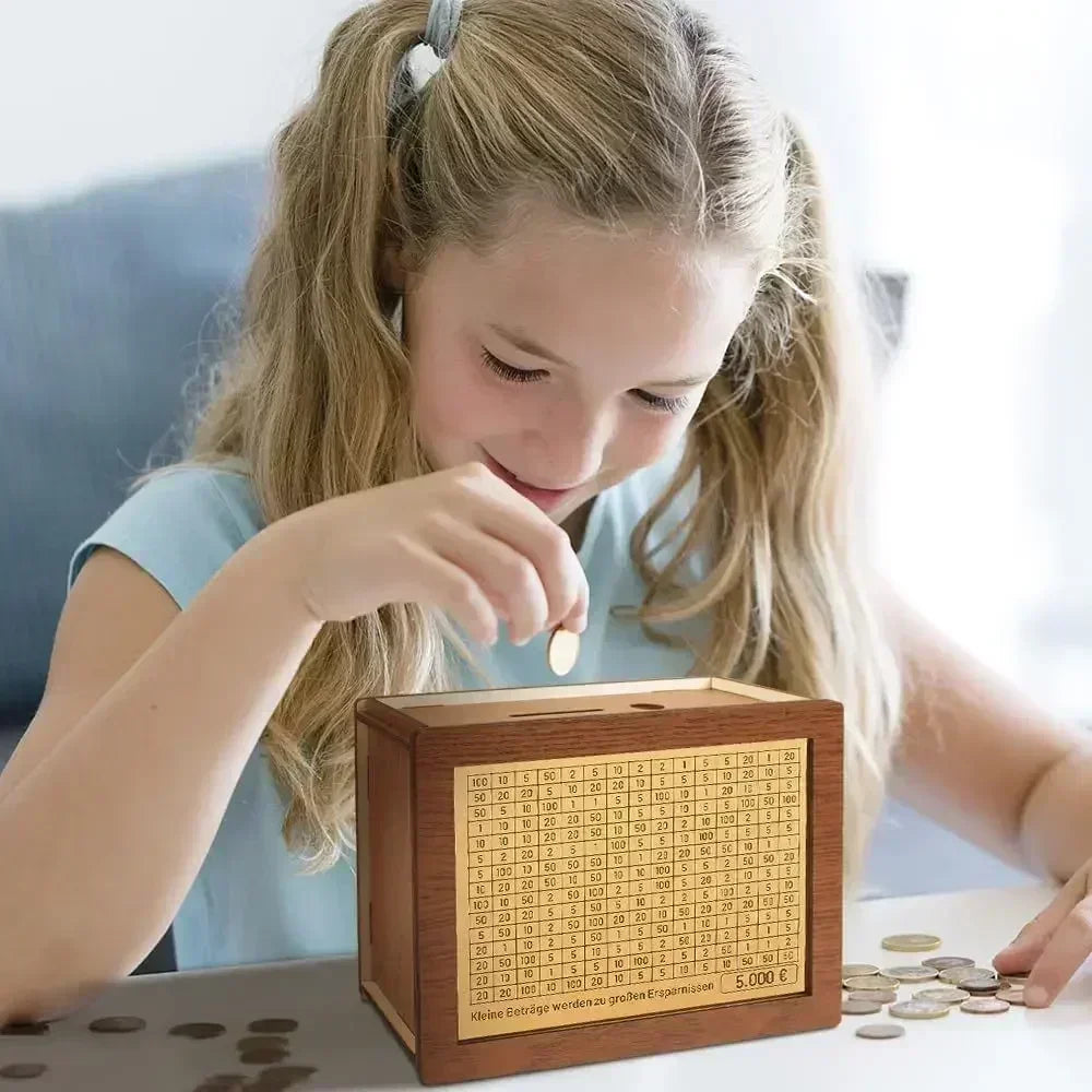 A young girl is using a reusable wooden piggy bank to save money, with coins scattered nearby.