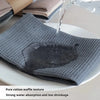 A gray cotton waffle weave towel is being filled with water on a white plate, demonstrating strong water absorption.