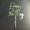 A silver acrylic birthday cake topper with the words Happy Birthday