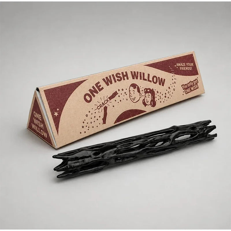 A wooden box labeled One Wish Willow with a dark stick inside, used as a night light projector.