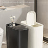 A black narrow gap trash bin with a press lid is shown next to a white version and a bathroom counter.