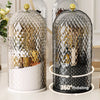 A clear glass makeup brush organizer with a lid featuring a geometric pattern and 360-degree rotating capability.