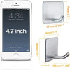 A white smartphone displaying a clock and date, next to stainless steel adhesive hooks with various sizes.