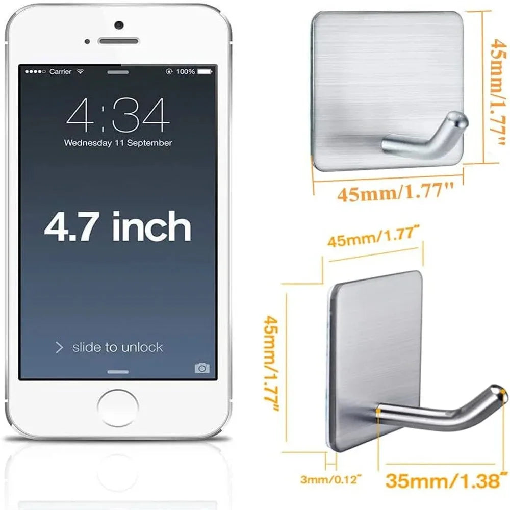 A white smartphone displaying a clock and date, next to stainless steel adhesive hooks with various sizes.
