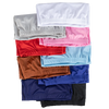 A stack of men's satin hair bonnets in various colors including white, gray, pink, red, orange, blue, and black.