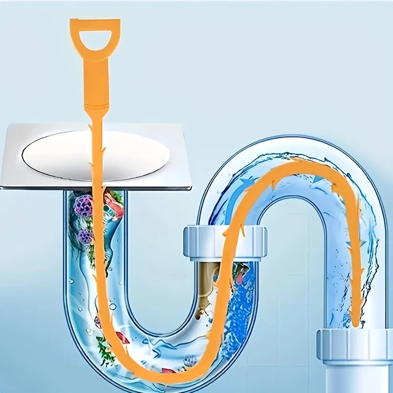Una herramienta flexible naranja para limpiar desagües, usada para despejar una tubería de plástico curva.
