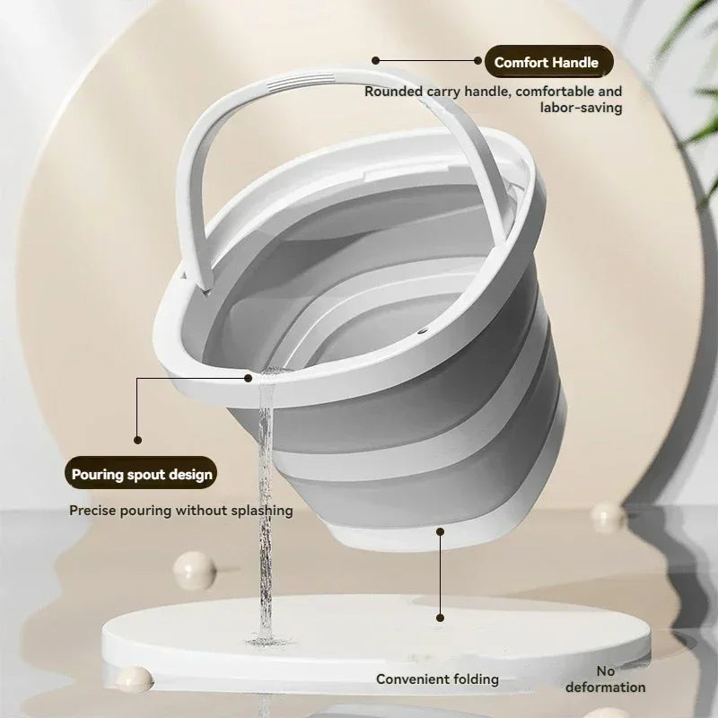 A white collapsible water bucket with a comfort handle and pouring spout design is shown on a stand.