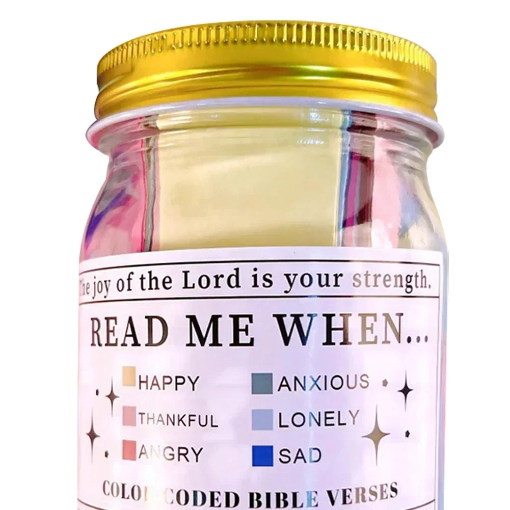 A glass jar of color-coded Bible verses with labels for emotions like happy, anxious, lonely, angry, and sad.