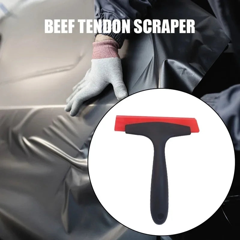 A hand wearing a glove is using a beef tendon scraper to clean a surface.