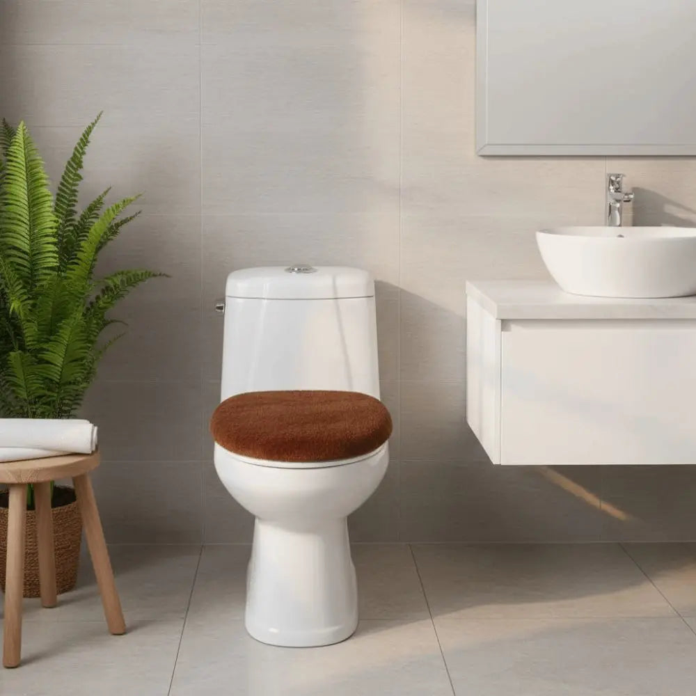 A white toilet with a brown seat cover is shown next to a white sink and cabinet in a modern bathroom.
