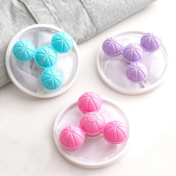 Three sets of reusable floating laundry filter bags in blue and purple colors resting on a white surface.