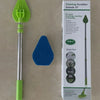 A green and silver retractable triangular floor scrubbing brush with a 3-in-1 cleaning extender is shown next to its packagin