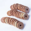A collection of round wooden blocks stacked in a spiral pattern for pest deterrents.