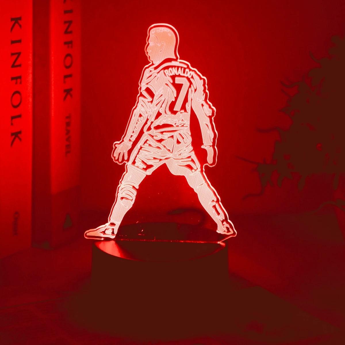 A glowing red silhouette of a basketball player wearing number 7 stands on a dark surface.