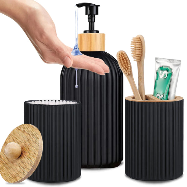 A hand is dispensing liquid from a black pump bottle into a cylindrical organizer set containing toothbrushes and a comb.