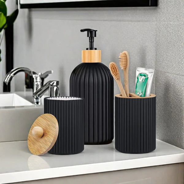 A set of black and wood apothecary style bathroom organizers including a pump bottle and cylindrical containers.