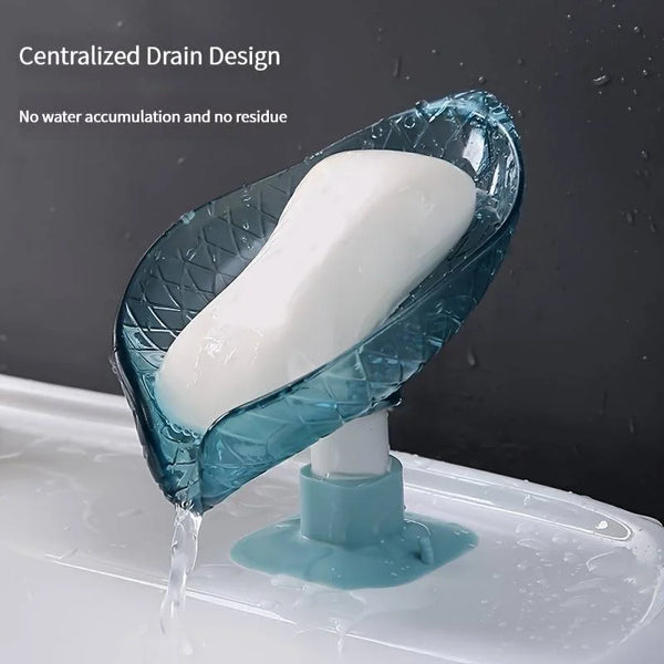 A leaf-shaped self-draining soap dish with a suction cup is shown draining water into a sink.