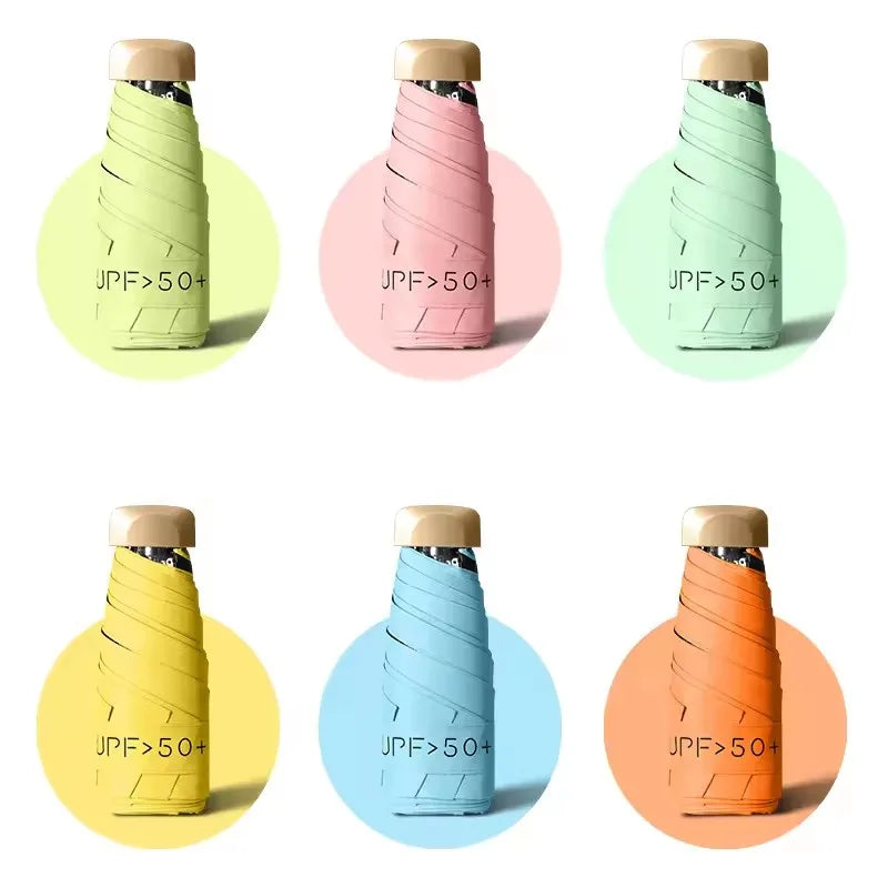 Various colored compact folding UV protection umbrellas shown in different shades of green, pink, yellow, and orange.
