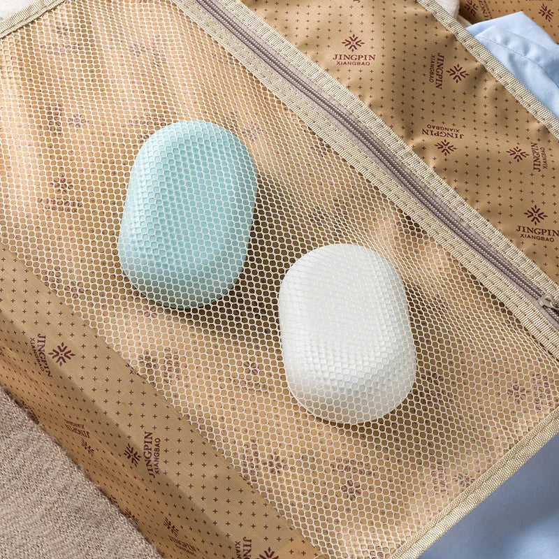 A portable soap holder with a lid, featuring a light blue and white textured soap, displayed in a woven brown bag.