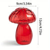 A glossy red glass mushroom vase with a textured cap and smooth body, shown against a white background.
