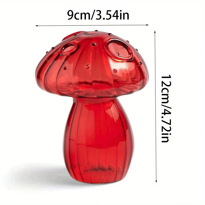A glossy red glass mushroom vase with a textured cap and smooth body, shown against a white background.