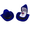 A royal blue velvet cowboy hat is displayed inside an open matching storage box with a silver ring.