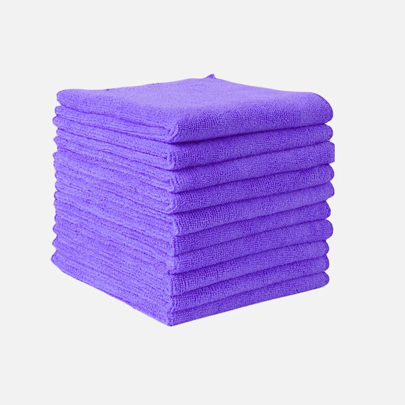 A stack of purple thickened microfiber cleaning cloths for glass and surfaces.