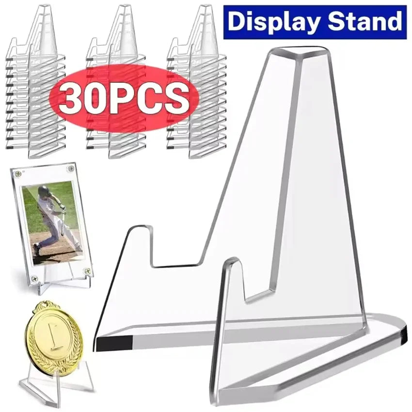 A set of clear acrylic display stands for collectibles, including multiple pieces and a gold medal.