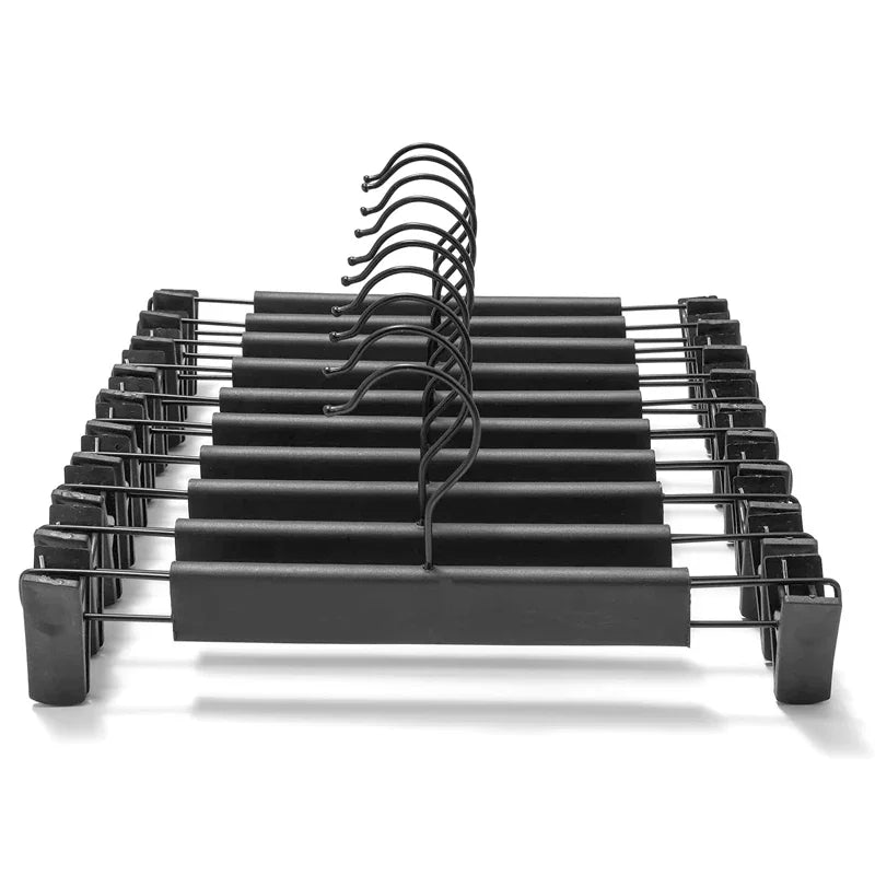 A black adjustable clothes hanger rack with multiple curved hangers for garments and bags.