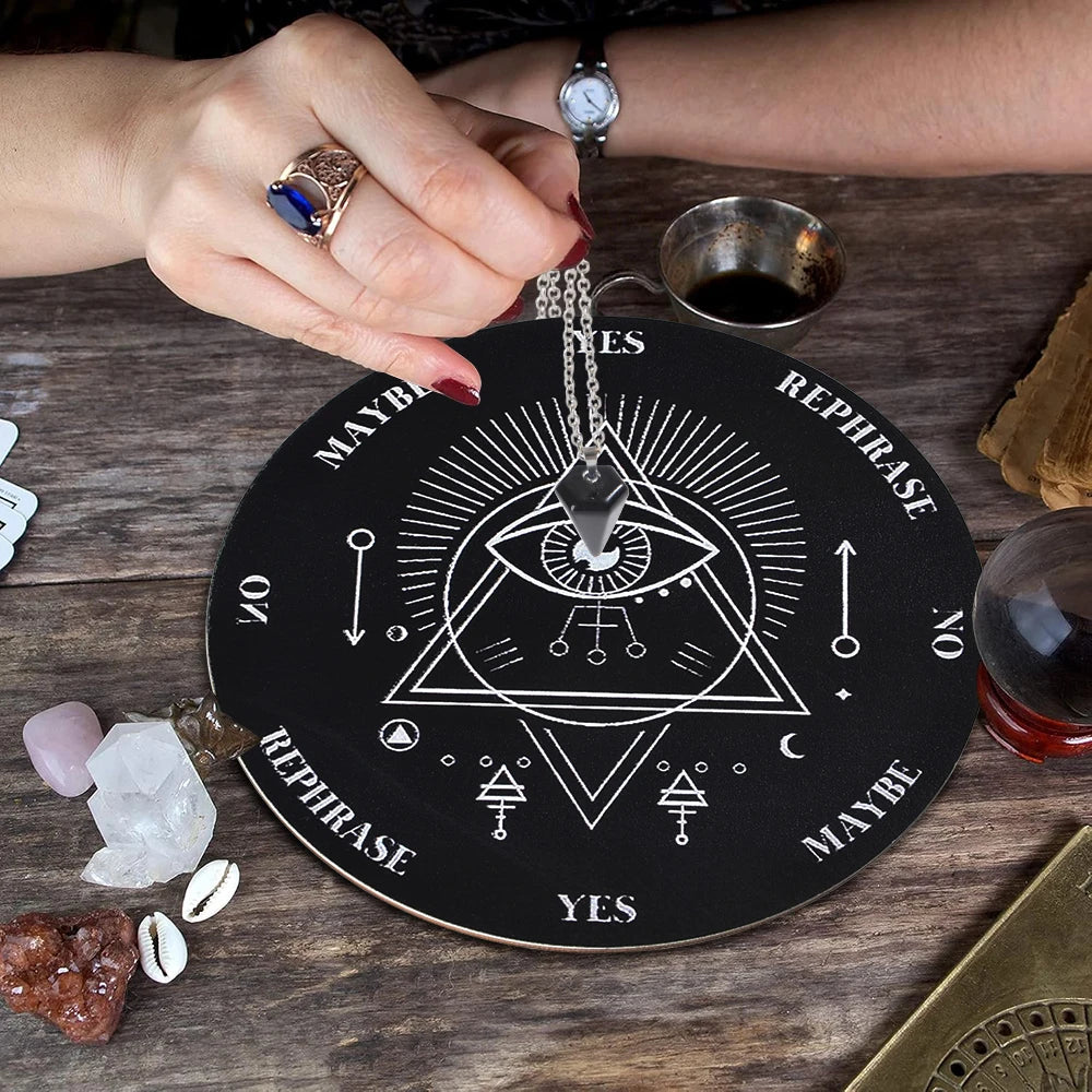 A hand holds a crystal necklace resting on a wooden divination altar set with various crystals and tools.