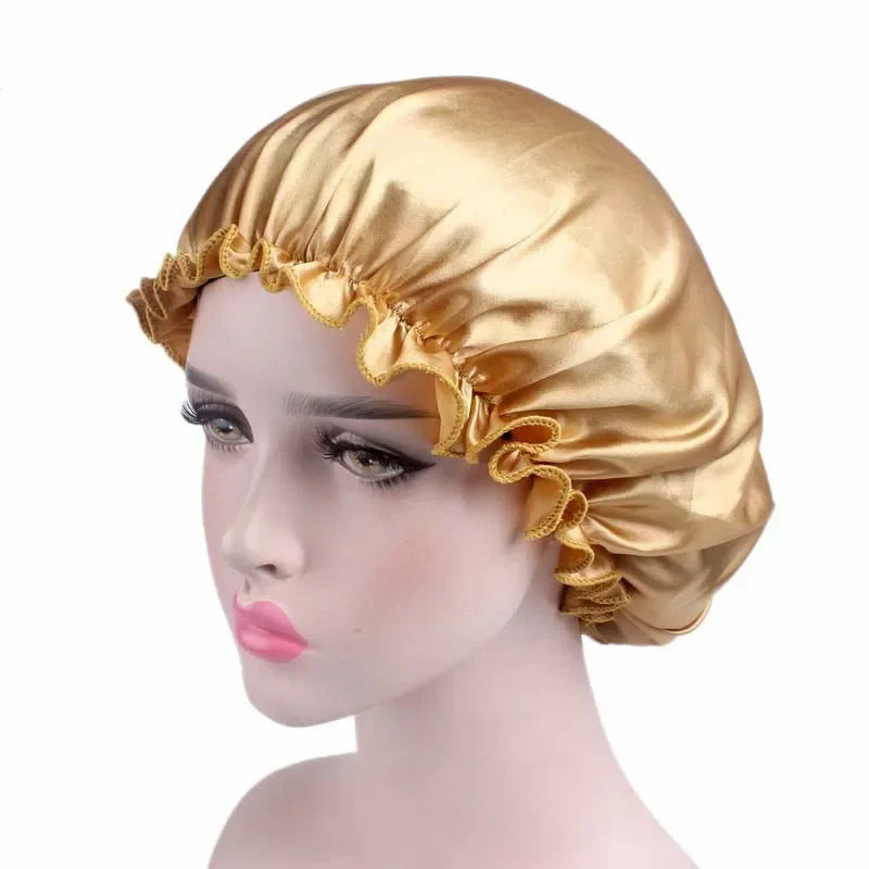 A golden satin sleep bonnet worn on a mannequin head.