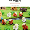 A collection of resin highland cow figurines in various colors and poses displayed on a green landscape setting.