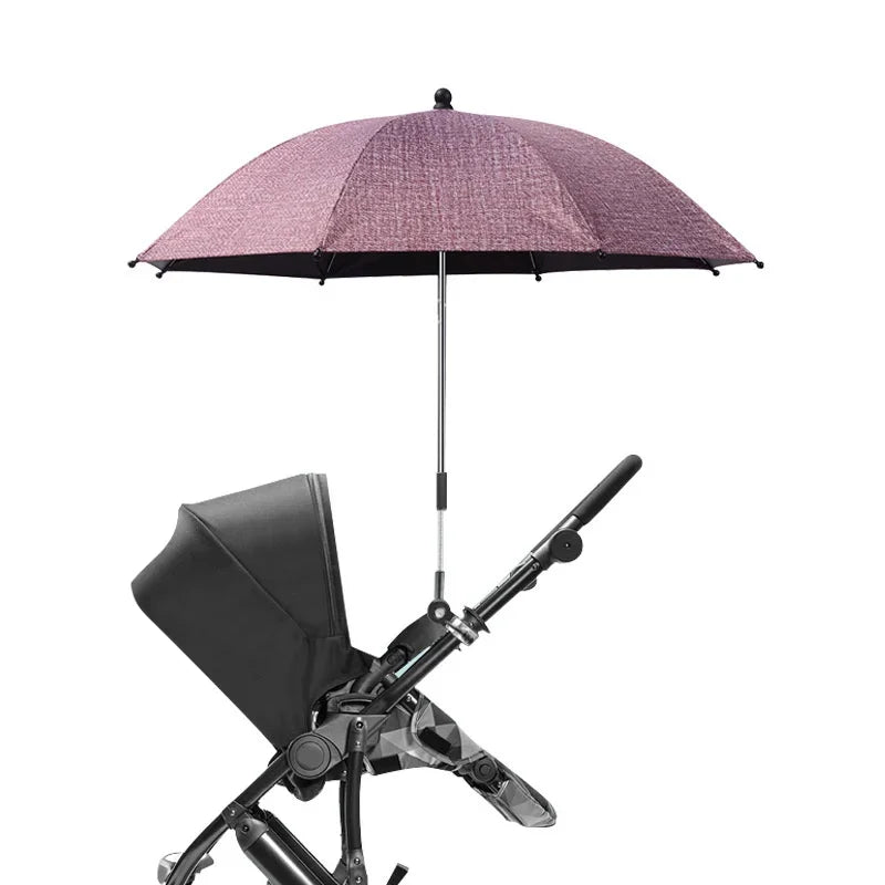 Paraguas para cochecito rosa con cubierta negra y soporte ajustable.
